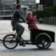 A photo of a mother cargo biking with her daughter on the bike | Copenhagen Private Biking Tour | 3 Hours | Amitylux Tours | Scandinavian Guided Tours | VIP & Luxury Experiences in the Nordics