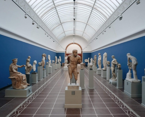 A photo of inside of Glyptotek Museum showing multiple statues | The Best 4 Museums in Copenhagen | Amitylux Tours | Guided City Tours | VIP & Luxury Experiences
