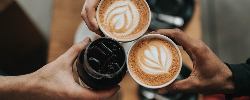 A photo of three cups of coffee being held by people | The Best 4 Tips For Visiting Copenhagen In Autumn | Amitylux Tours | Scandinavian Guided Tours | VIP & Luxury Experiences in the Nordics