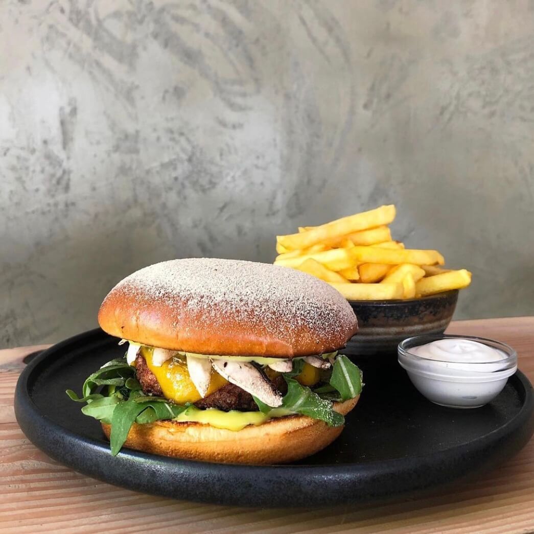 A photo of a burger, fries, and dip from Souls | The Best Vegan Restaurants in Copenhagen | Amitylux Tours | Scandinavian Guided Tours | VIP & Luxury Experiences in the Nordics