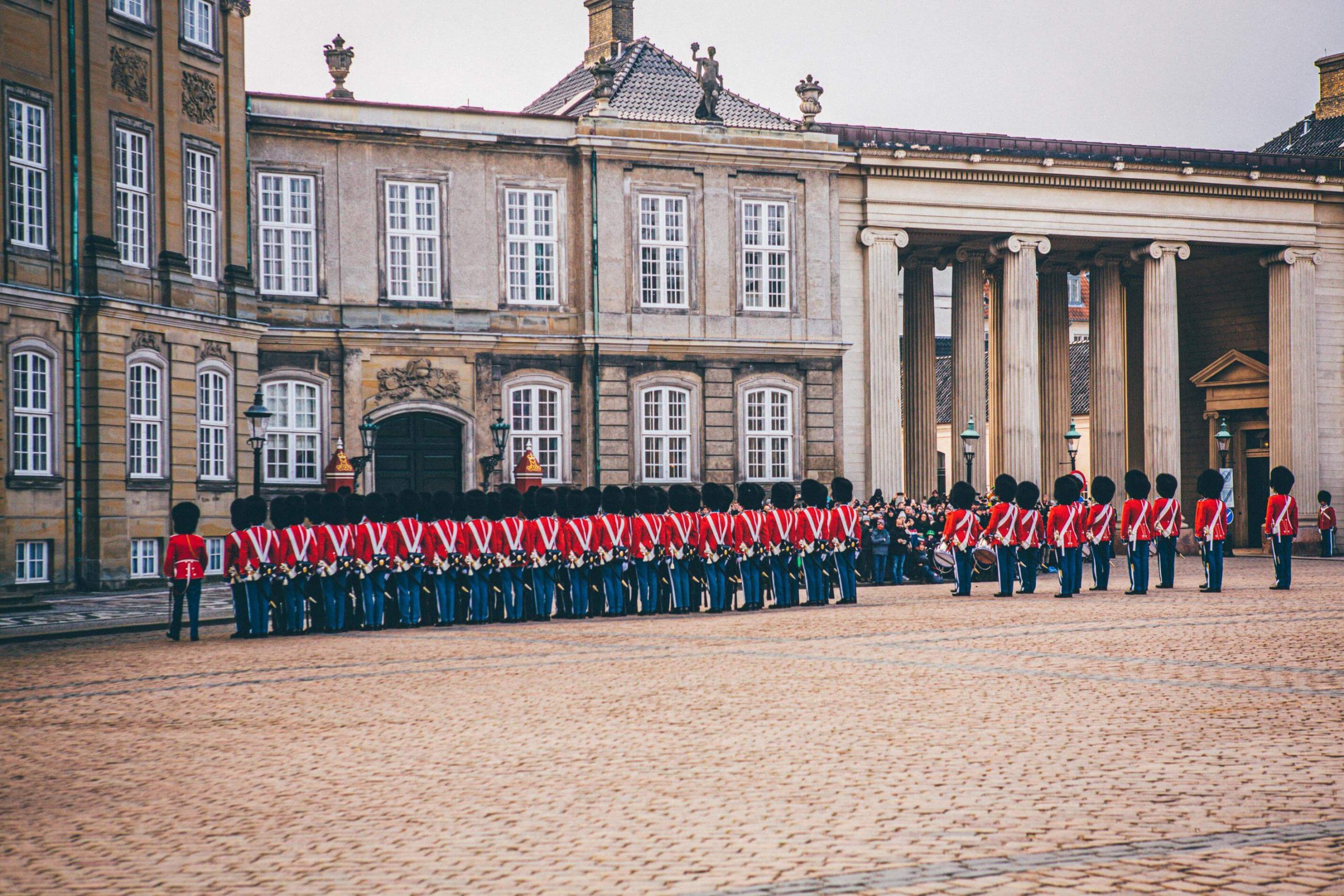 A photo outside of the Amalienborg Palace showing the Royal Guard | The Best Architectural Buildings in Copenhagen | Amitylux Tours | Scandinavian Guided Tours | VIP & Luxury Experiences in the Nordics