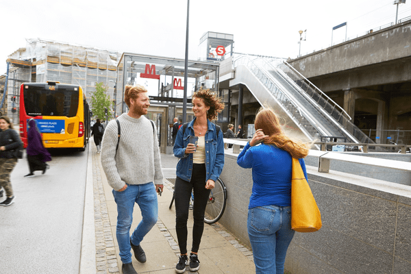 A photo of people talking outside the Metro station