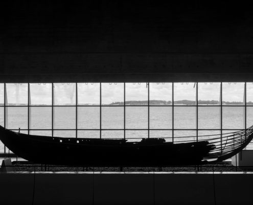 A photo of a Viking ship located inside the Viking Ship Museum | The Best 5 Museums in Denmark | Amitylux Tours | Guided City Tours | VIP & Luxury Experiences