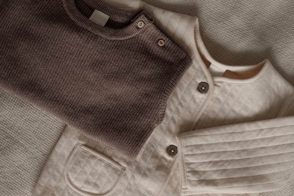A photo of a brown blouze and creme jacket