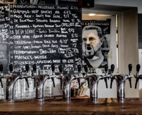 A bar photo of Fermentøren's bar showing the bar and its beer taps | The Best Beer Bars in Copenhagen: Our Top 4 Favorite | Amitylux Tours | Guided City Tours | VIP & Luxury Experiences
