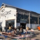 An outside photo of Mikkeller showing people sitting outside on benches drinking beer | The Best Beer Bars in Copenhagen: Our Top 4 Favorite | Amitylux Tours | Scandinavian Guided Tours | VIP & Luxury Experiences in the Nordics