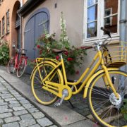 A yellow bike parked across a house | Danes and Bikes | Danes and Bikes: A Powerful and Unique Relationship | Amitylux Tours | Guided City Tours | VIP & Luxury Experiences