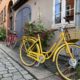 A yellow bike parked across a house | Danes and Bikes | Danes and Bikes: A Powerful and Unique Relationship | Amitylux Tours | Scandinavian Guided Tours | VIP & Luxury Experiences in the Nordics