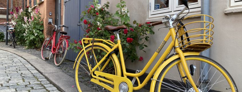 A yellow bike parked across a house | Danes and Bikes | Danes and Bikes: A Powerful and Unique Relationship | Amitylux Tours | Scandinavian Guided Tours | VIP & Luxury Experiences in the Nordics