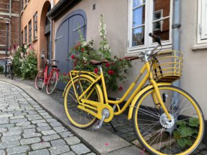 A yellow bike parked across a house | Danes and Bikes | Danes and Bikes: A Powerful and Unique Relationship | Amitylux Tours | Guided City Tours | VIP & Luxury Experiences