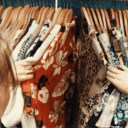 female thrift shopping colorful shirts