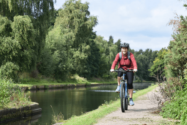 a woman biking on Regent's Canal Towpath