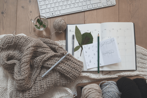 a knitting yarn with a book on a table