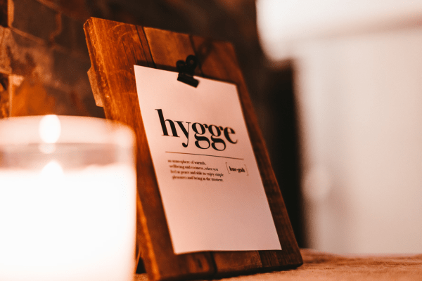 a wooden board with hygge written on a paper