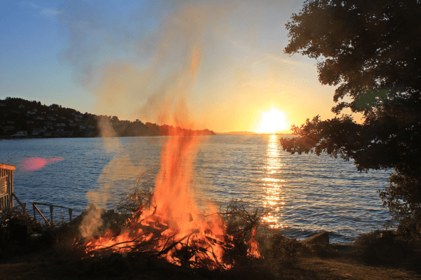 bonfire burning with a sunset view of the sea