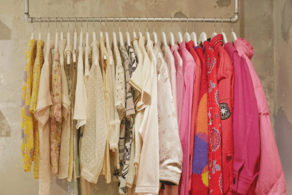 colorful female vintage tops hanging on a clothing rack