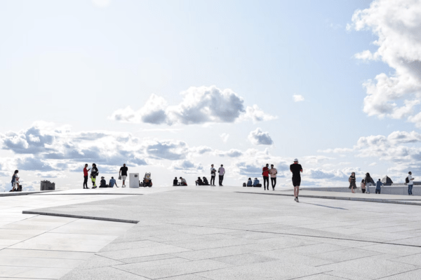 white clouds with people on the sidewalk